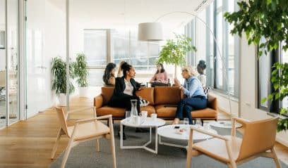 Businesswomen on a break in a modern NYC office, highlighting evolving workspace trends.