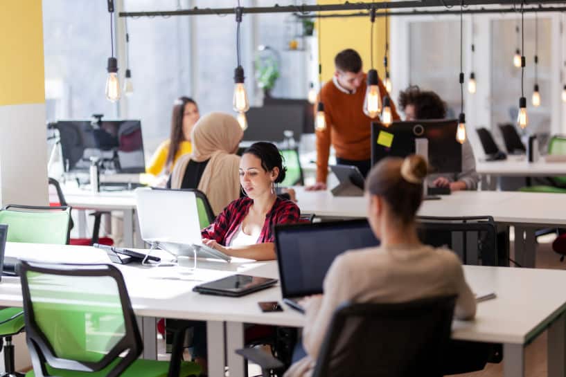 Young creative team working on desktops in a contemporary office environment