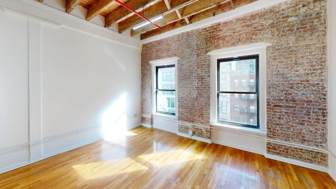 A bright room at 37-39 West 14th Street with exposed brick walls.